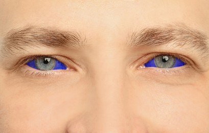 Closeup view of man with eyeballs tattoo