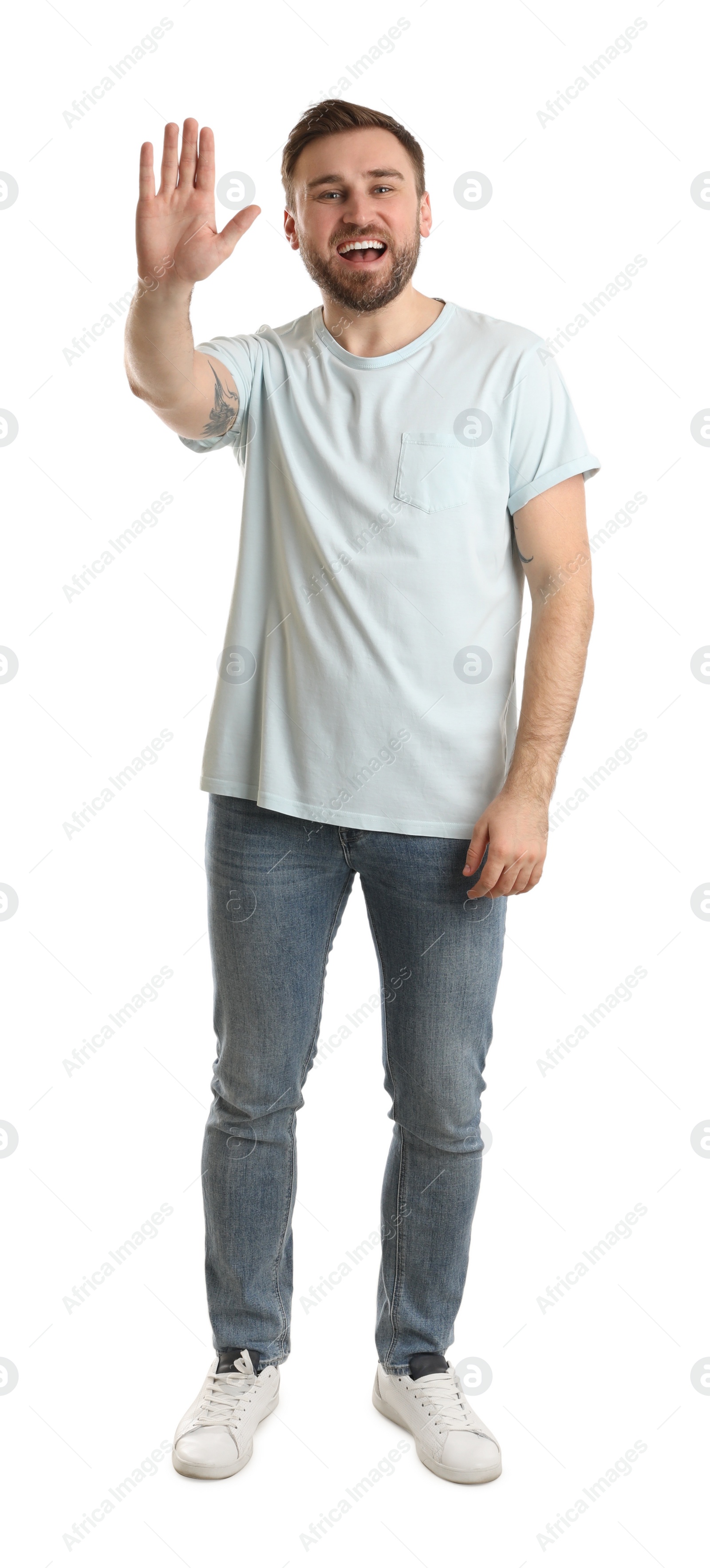 Photo of Happy young man waving to say hello on white background