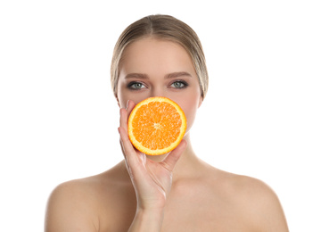 Photo of Young woman with cut orange on white background. Vitamin rich food