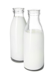 Photo of Bottles of tasty milk isolated on white