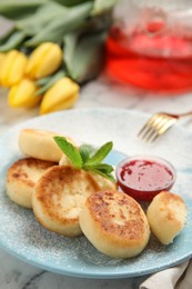 Photo of Delicious cottage cheese pancakes with jam, mint and icing sugar on white marble table