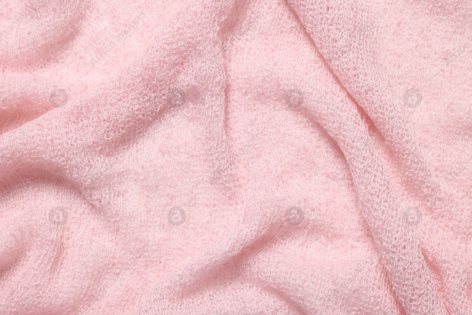 Photo of Texture of soft pink crumpled fabric as background, top view