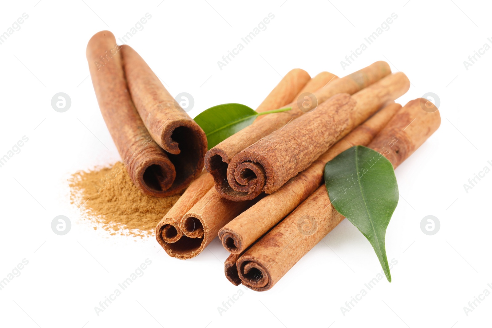 Photo of Dry aromatic cinnamon sticks, powder and green leaves isolated on white