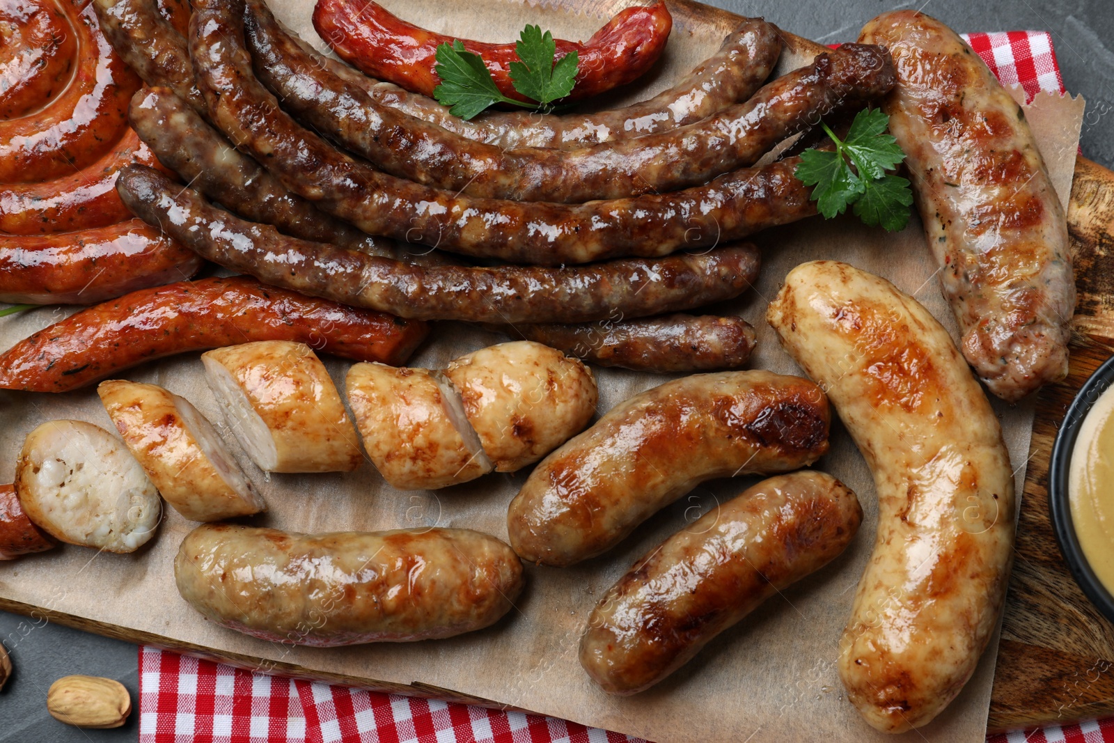 Photo of Set of different tasty snacks and beer on dark grey table, top view