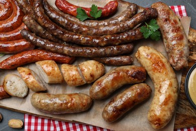 Set of different tasty snacks and beer on dark grey table, top view