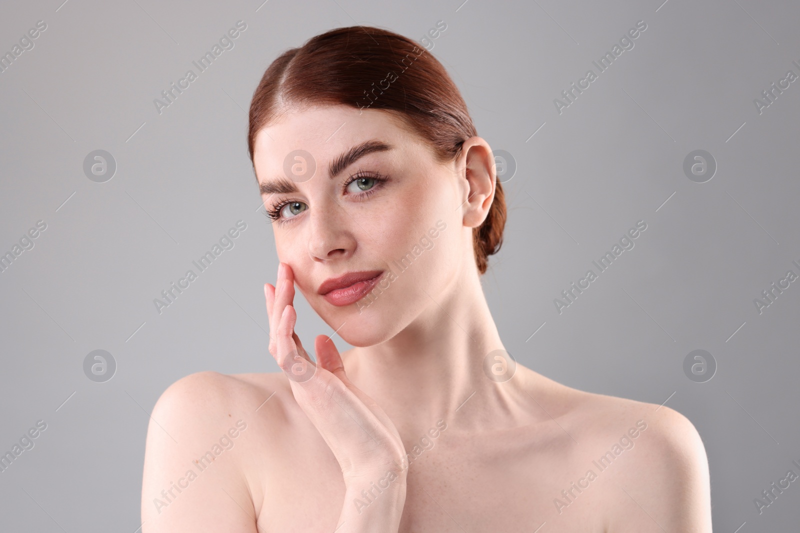 Photo of Portrait of beautiful woman on grey background