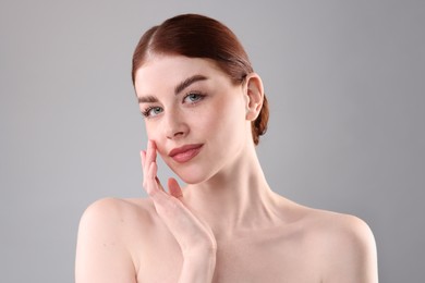 Portrait of beautiful woman on grey background