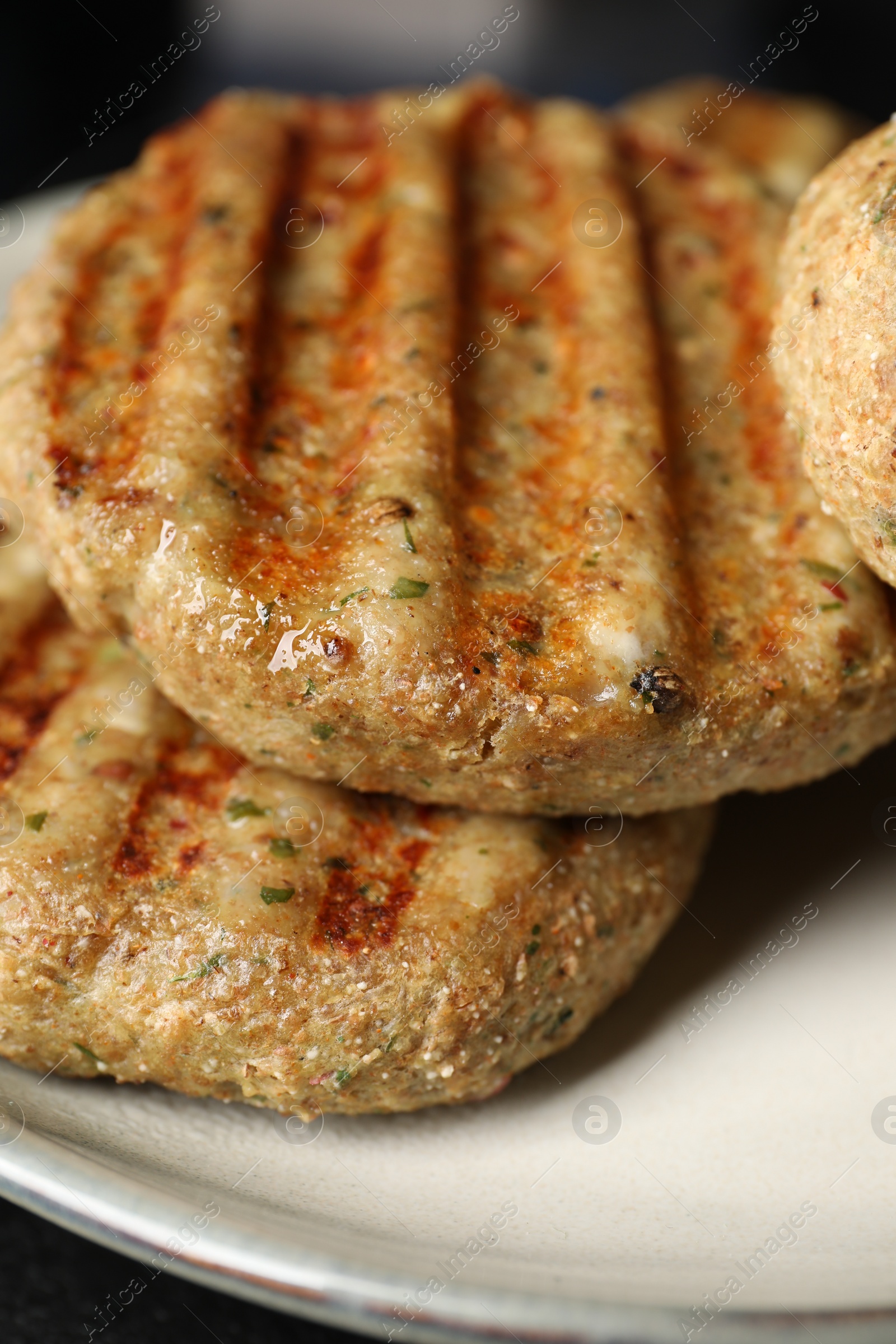 Photo of Delicious grilled vegan cutlets on plate, closeup