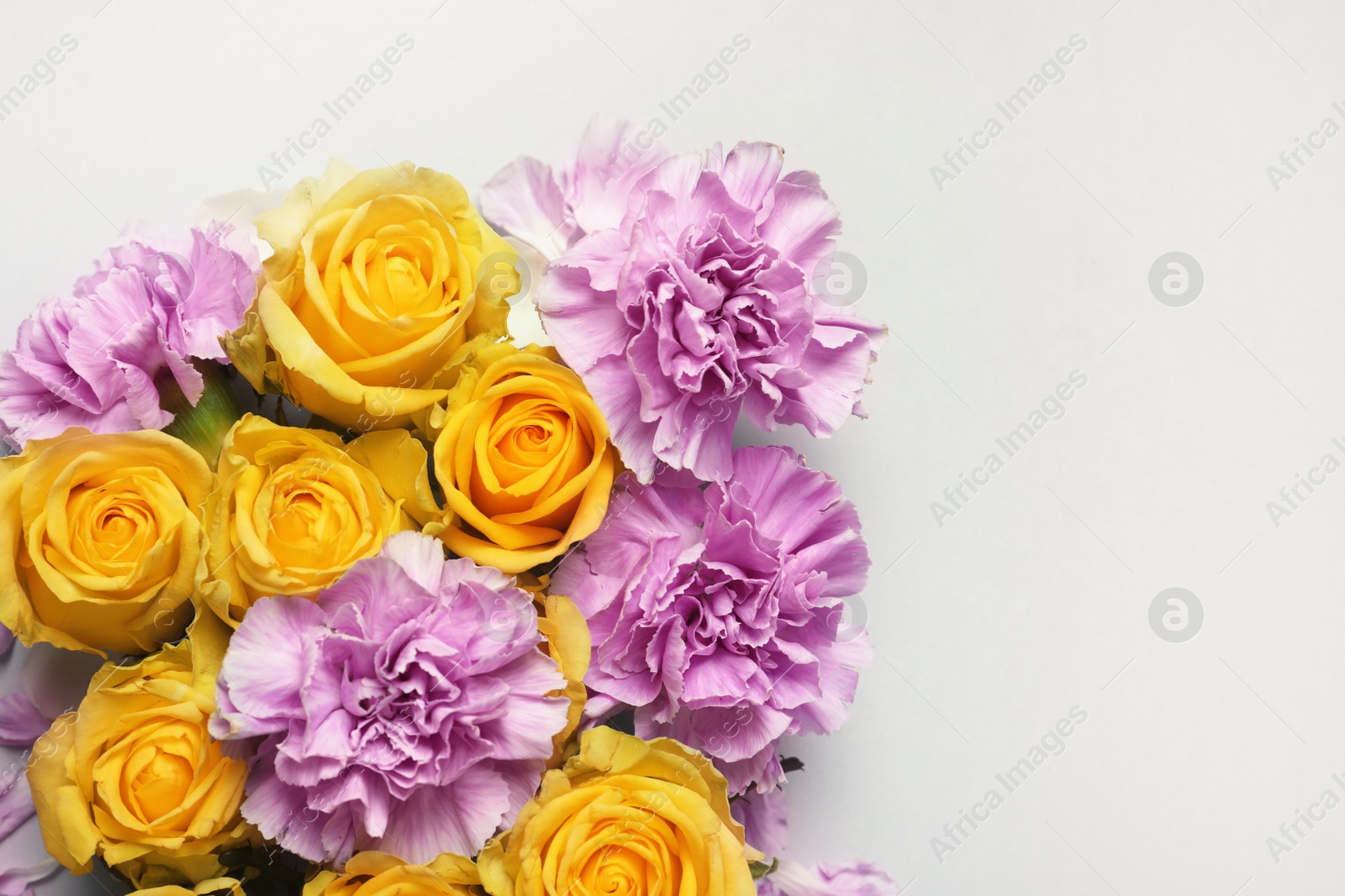 Photo of Beautiful blooming flowers on grey background, top view