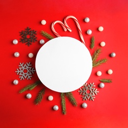 Flat lay composition with Christmas decor on red background