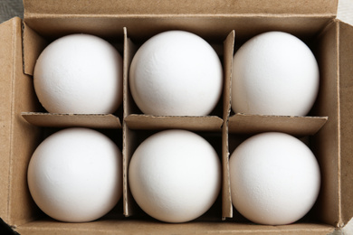 Fresh raw chicken eggs in box, top view