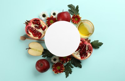 Photo of Flat lay composition with Rosh Hashanah holiday attributes and card on light blue background. Space for text