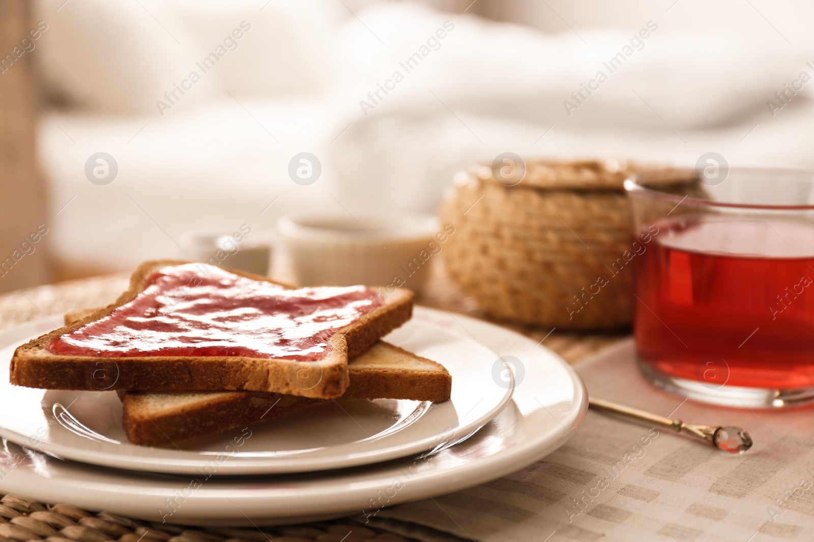 Photo of Toasts and tea on table indoors. Delicious morning meal