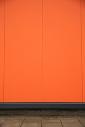 Beautiful orange wall and stone pavement outdoors