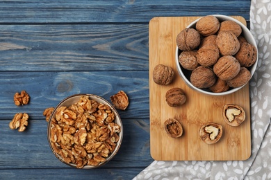 Flat lay composition with walnuts and space for text on wooden background