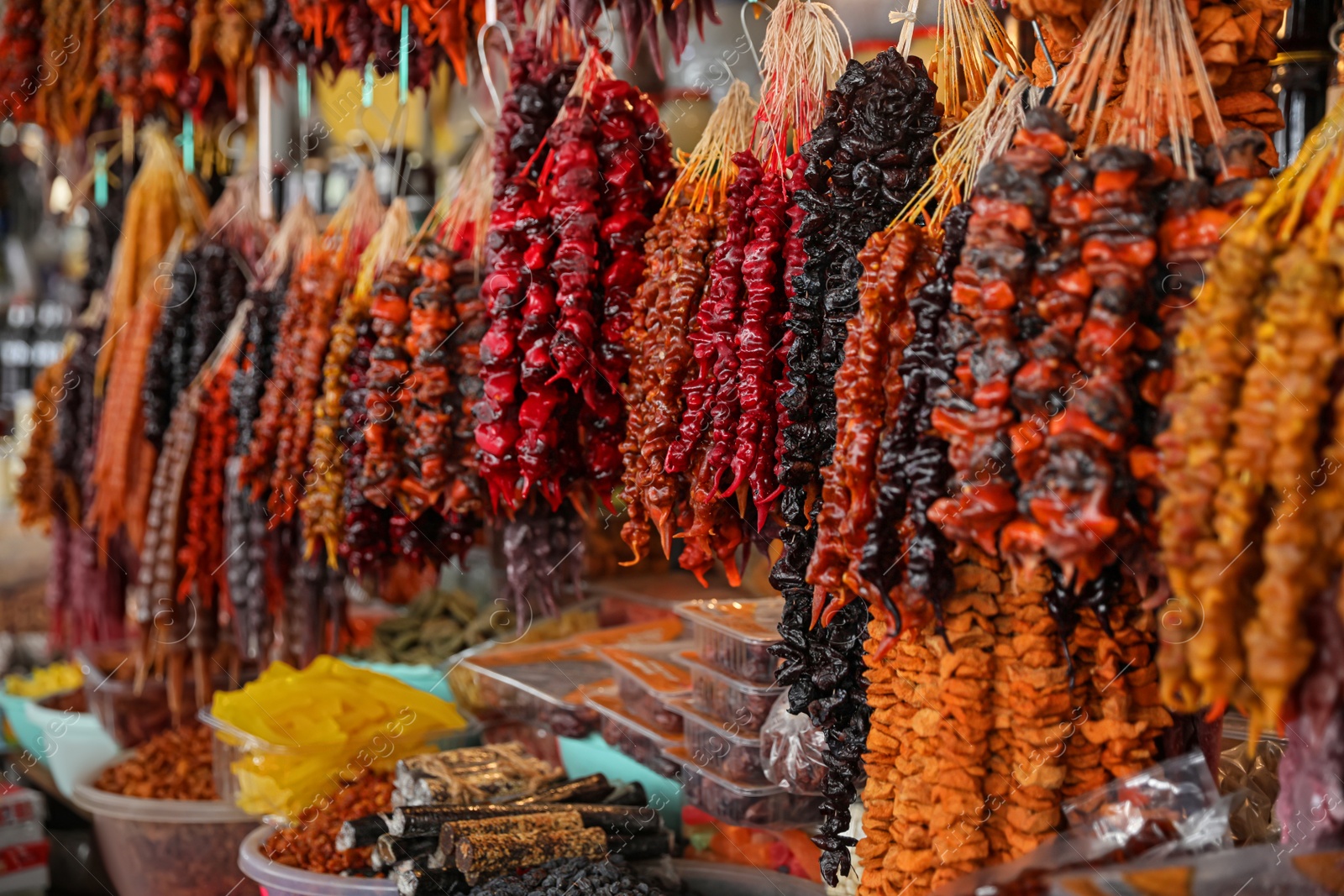 Photo of Bunches of different delicious churchkhelas at market