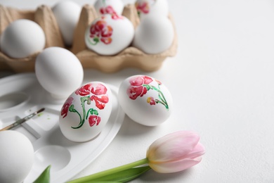 Photo of Painting Easter eggs on white table, space for text