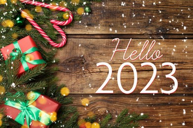 Image of Hello 2023. Flat lay composition with fir tree branches and festive decor on wooden background