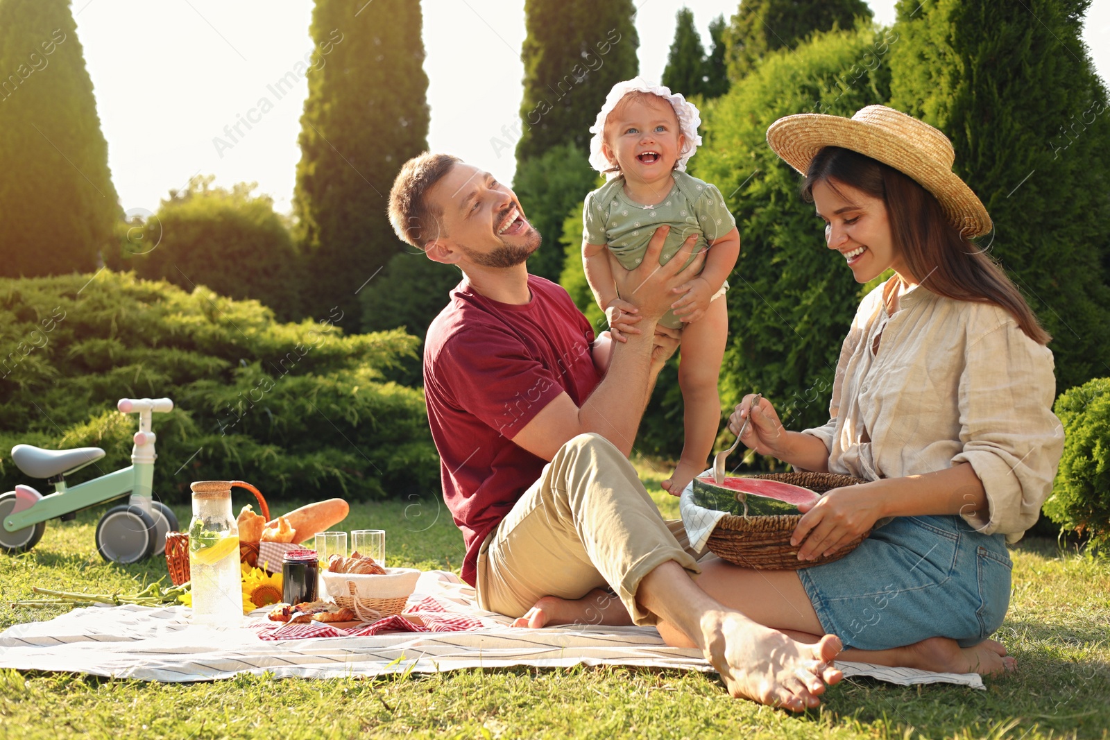 Photo of Happy family having picnic in garden on sunny day