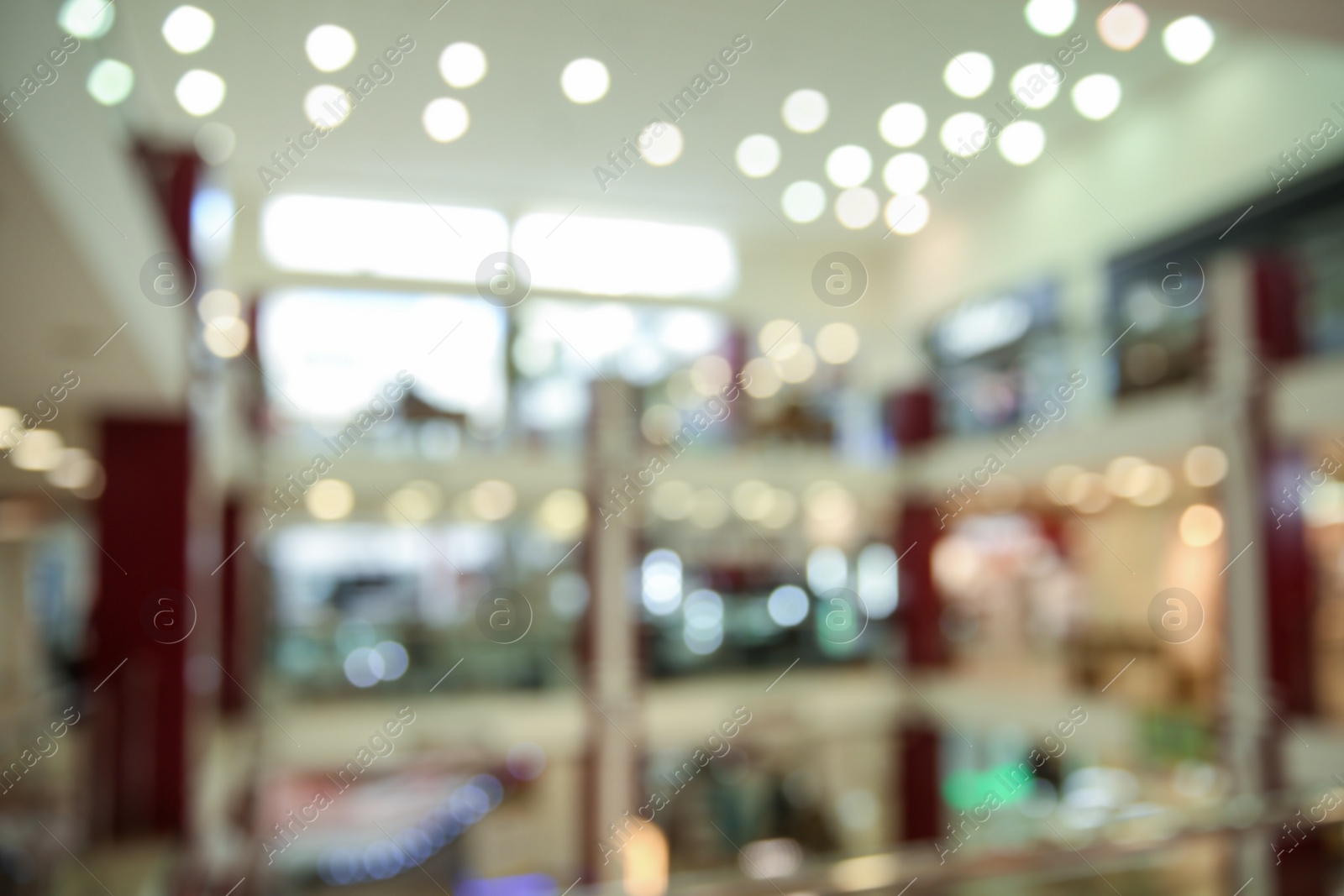 Photo of Blurred view of modern shopping mall interior