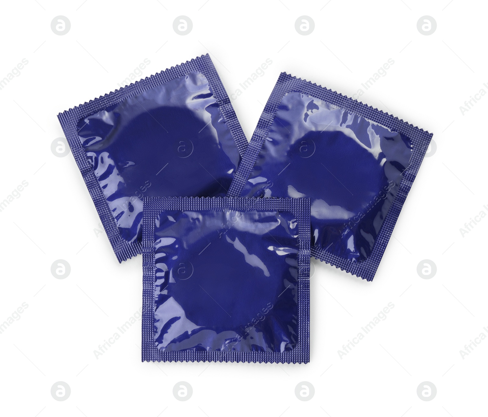 Photo of Packaged condoms on white background, top view. Safe sex