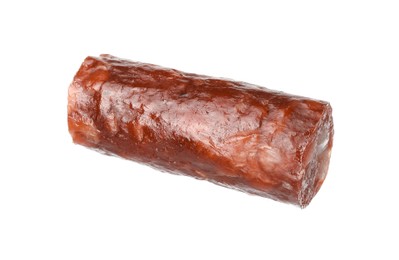 Photo of Piece of thin dry smoked sausage isolated on white