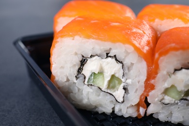 Tasty sushi rolls in box, closeup. Food delivery service