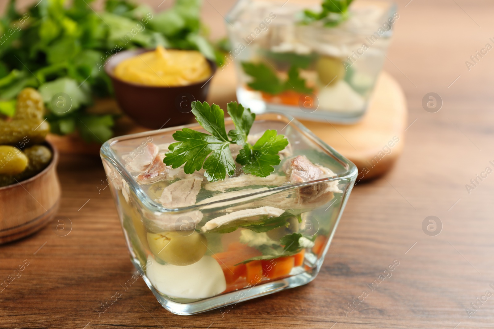 Photo of Delicious aspic with meat served on wooden table