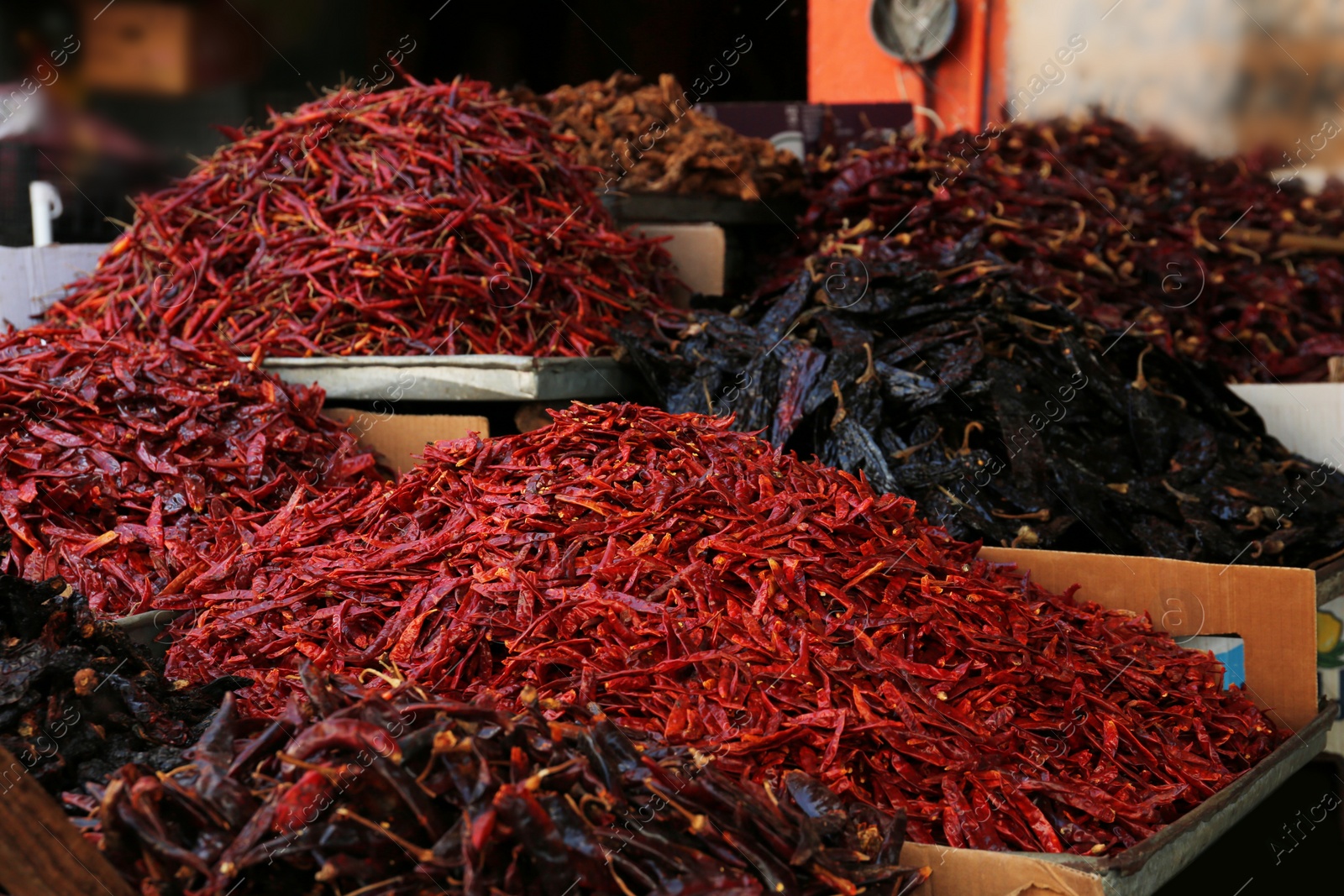 Photo of Heap of dried peppers on counter at market