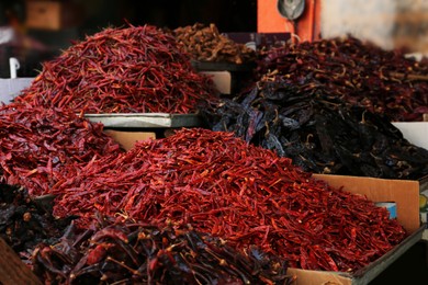 Photo of Heap of dried peppers on counter at market
