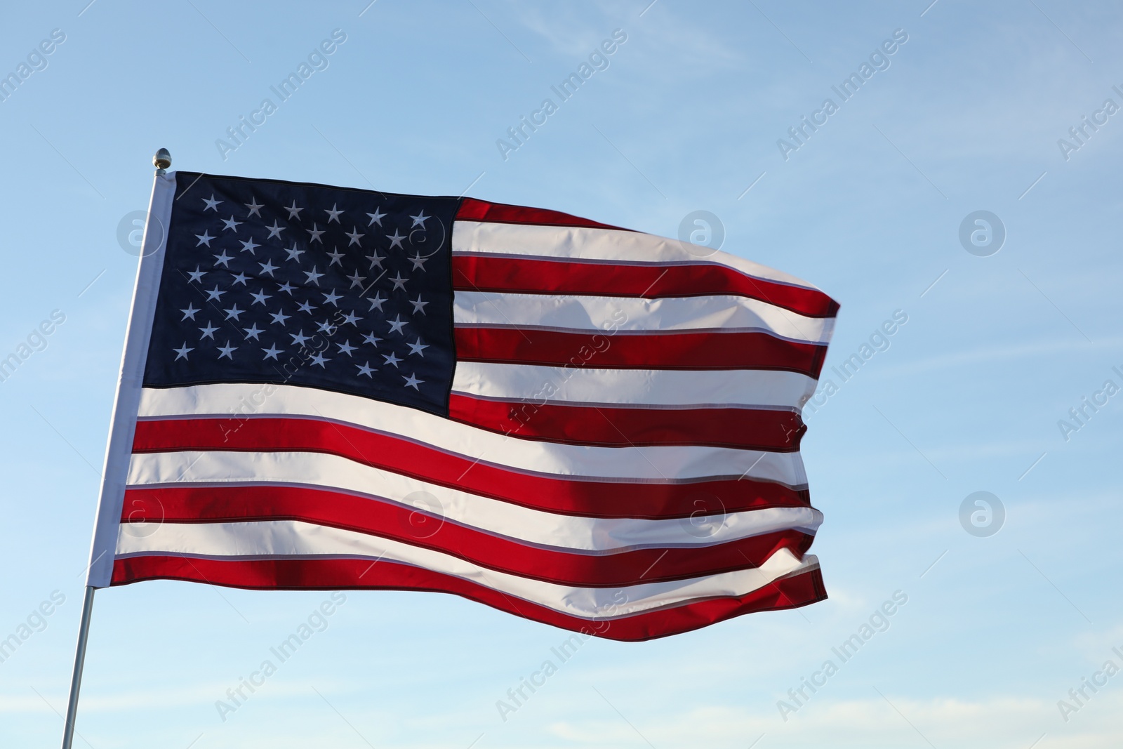 Photo of American flag fluttering outdoors on sunny day