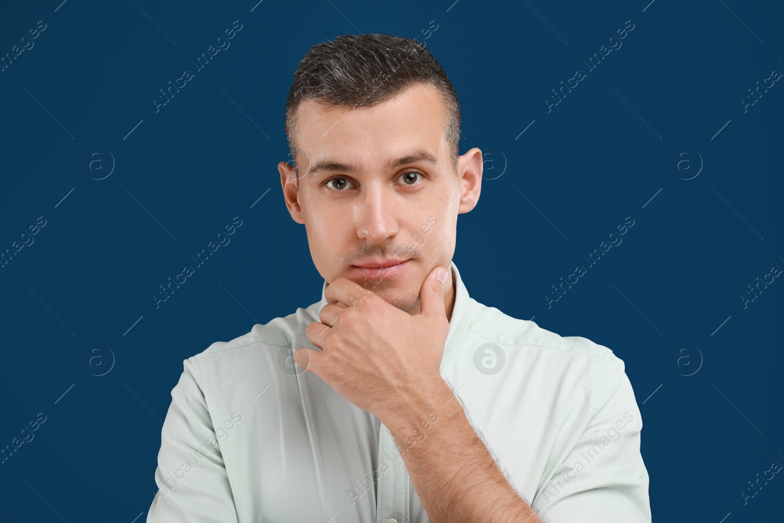 Photo of Portrait of handsome man on blue background