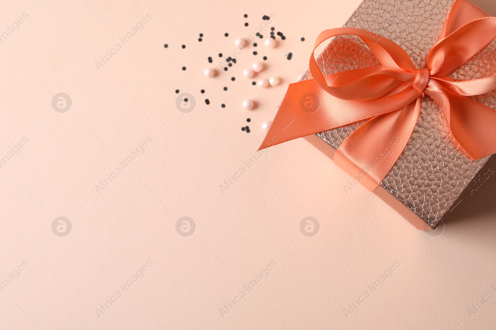 Photo of Beautiful gift box and decor on pink background, flat lay. Space for text