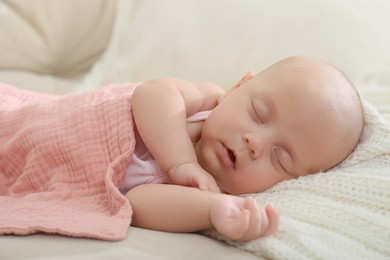 Cute little baby sleeping on blanket at home