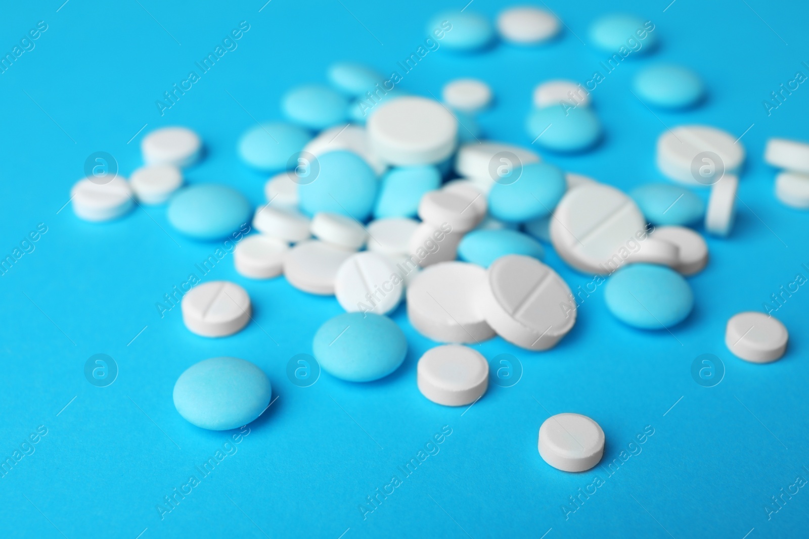 Photo of Many different pills on color surface, closeup