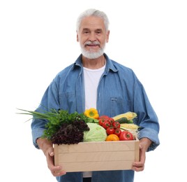 Harvesting season. Happy farmer holding wooden crate with vegetables on white background