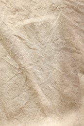 Photo of Beautiful beige fabric as background, top view