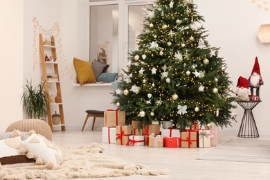 Beautiful Christmas tree and gift boxes in living room. Interior design