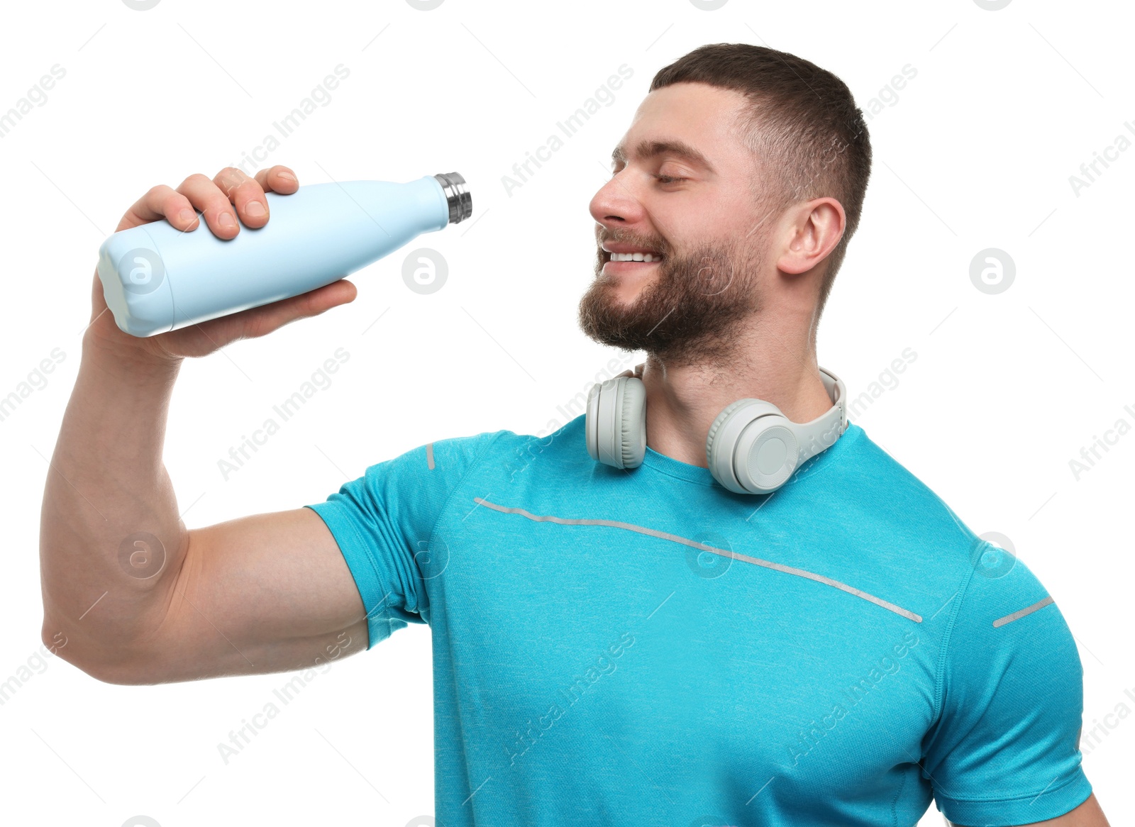 Photo of Handsome man with thermo bottle and headphones on white background