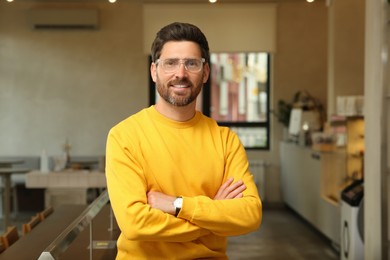 Portrait of handsome stylish man in cafe