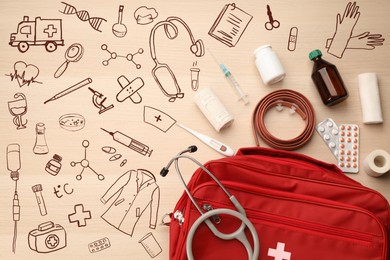 First aid kit and different images on wooden table, flat lay