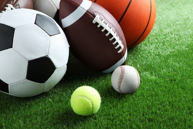 Photo of Set of different sport balls on green grass
