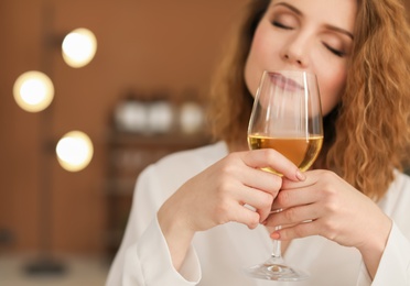 Photo of Woman with glass of delicious wine indoors