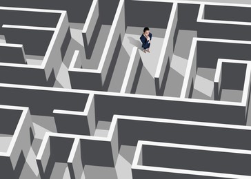 Image of Thoughtful businesswoman trying to find way out of maze