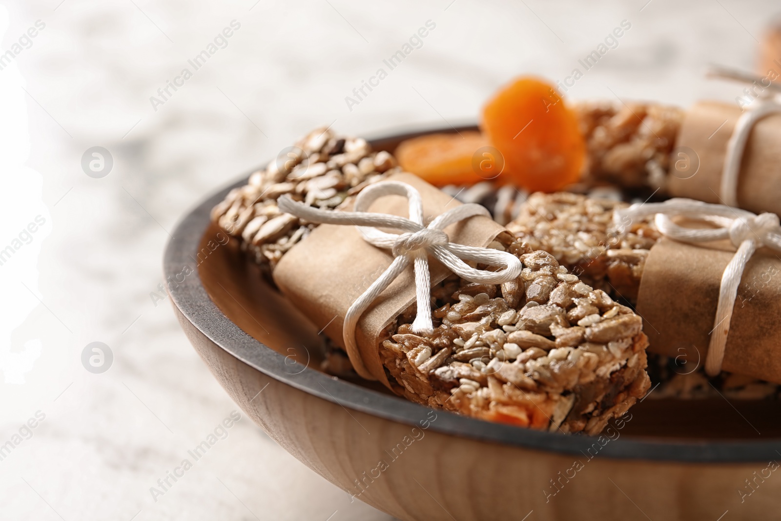 Photo of Homemade grain cereal bars on plate, closeup. Healthy snack