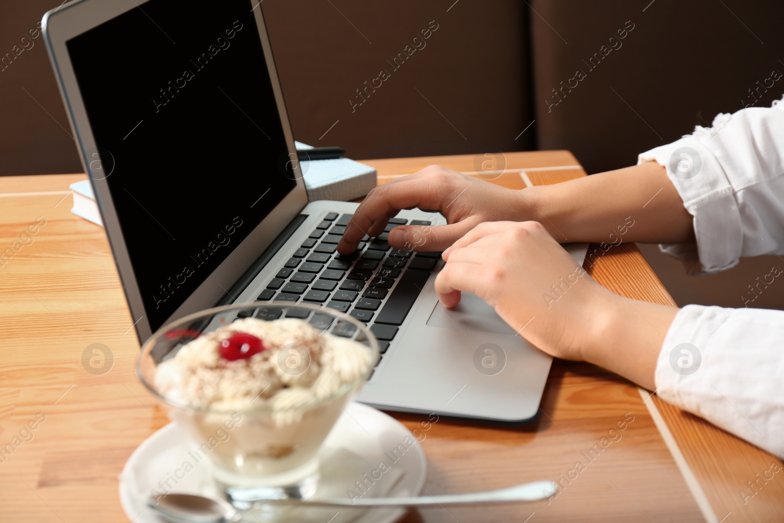 Photo of Blogger working with laptop in cafe, closeup