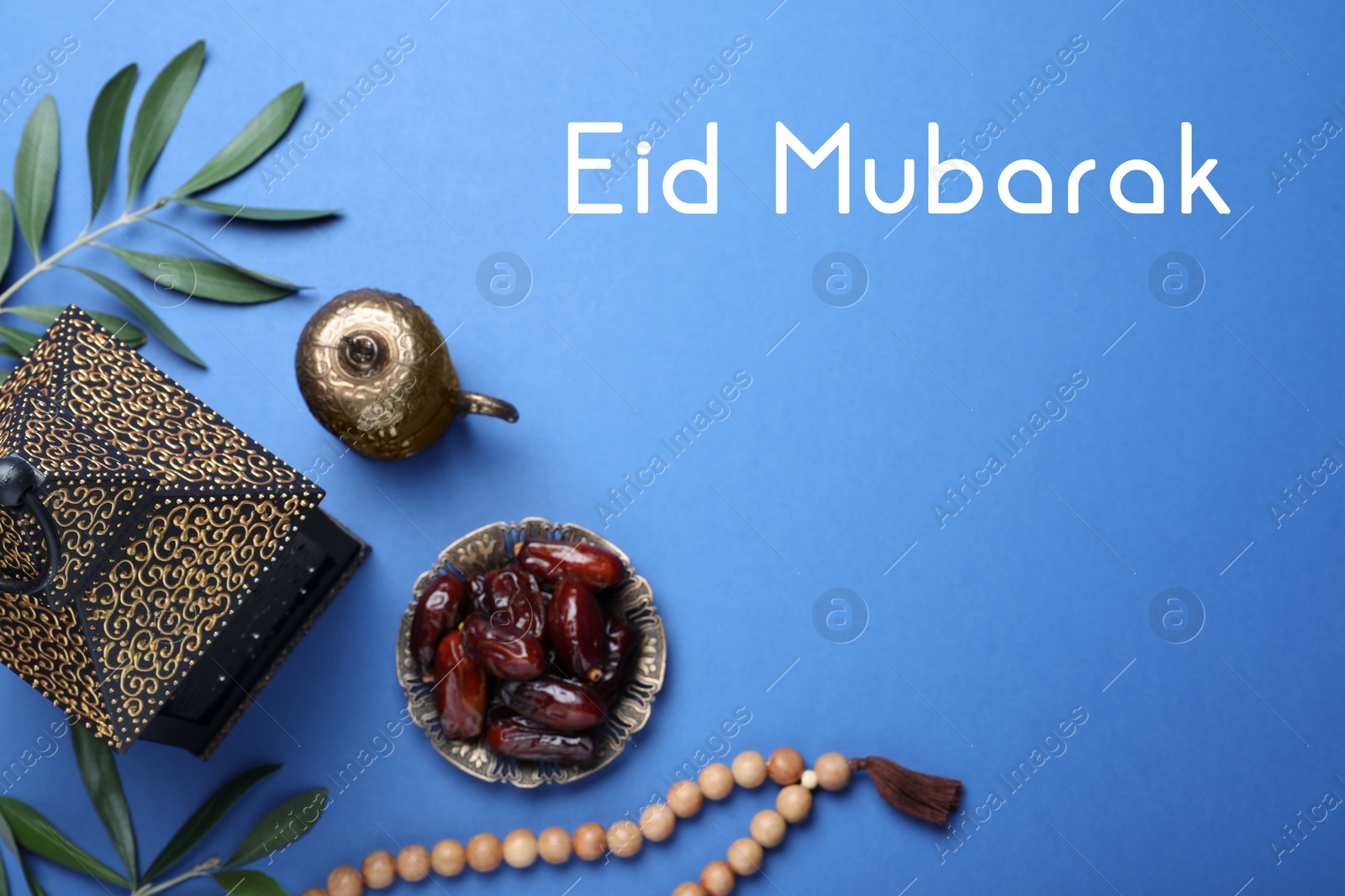 Image of Eid Mubarak greeting card. Flat lay composition with Arabic lantern and misbaha on blue background