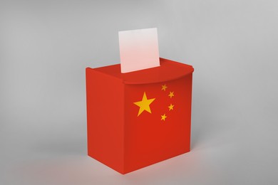 Ballot box decorated with flag of China on light background
