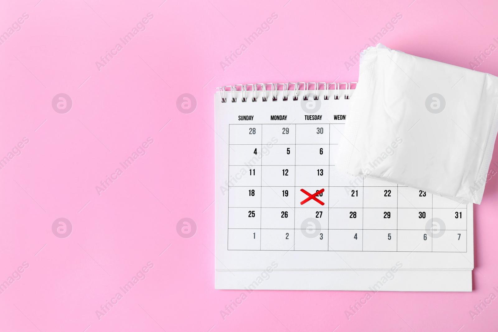 Photo of Packed menstrual pads and calendar on color background, flat lay with space for text. Gynecological care