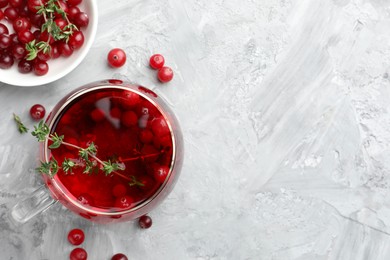 Photo of Delicious cranberry tea with thyme and berries on grey table, flat lay. Space for text